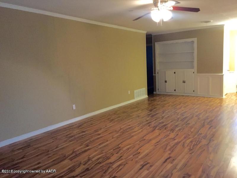 3313 Lombard Road Amarillo, TX 79106 - Photo 5 of 20 an empty room with wooden floor closet and windows