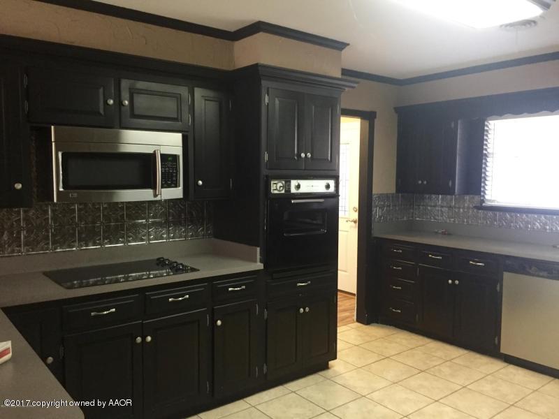 3313 Lombard Road Amarillo, TX 79106 - Photo 7 of 20 a kitchen with a refrigerator and a stove top oven