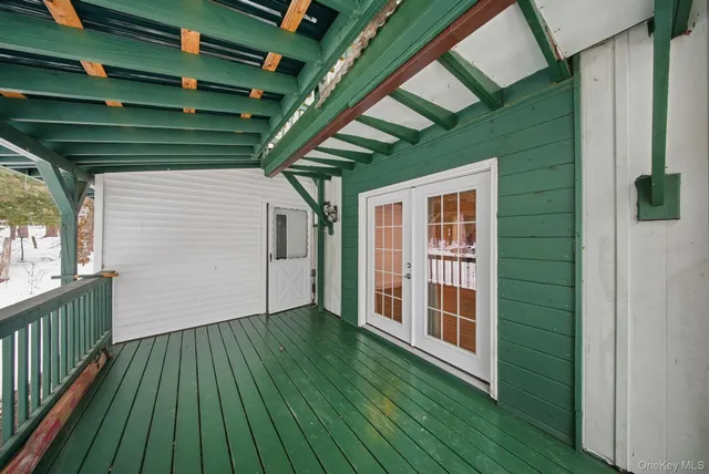 a view of a small house with wooden fence