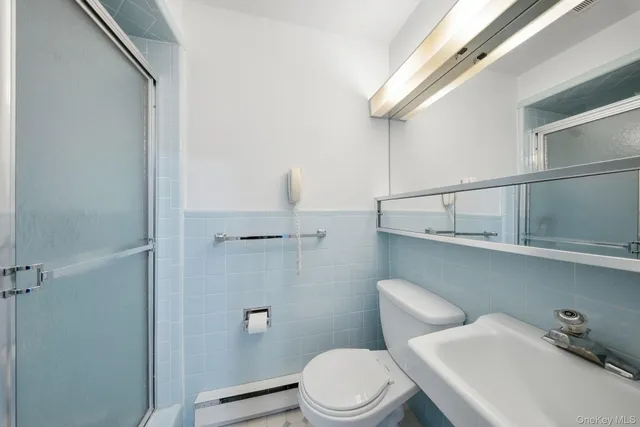 a white toilet sitting next to a bathroom sink
