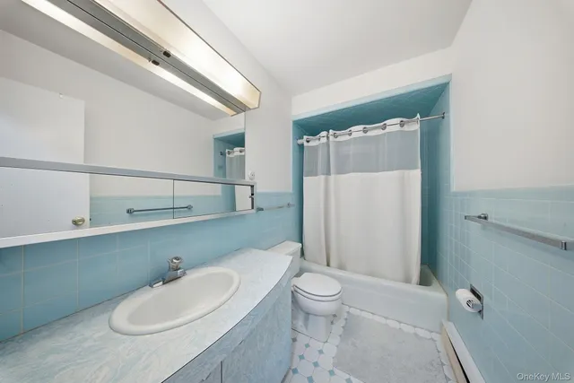 a bathroom with a sink a toilet a mirror and shower