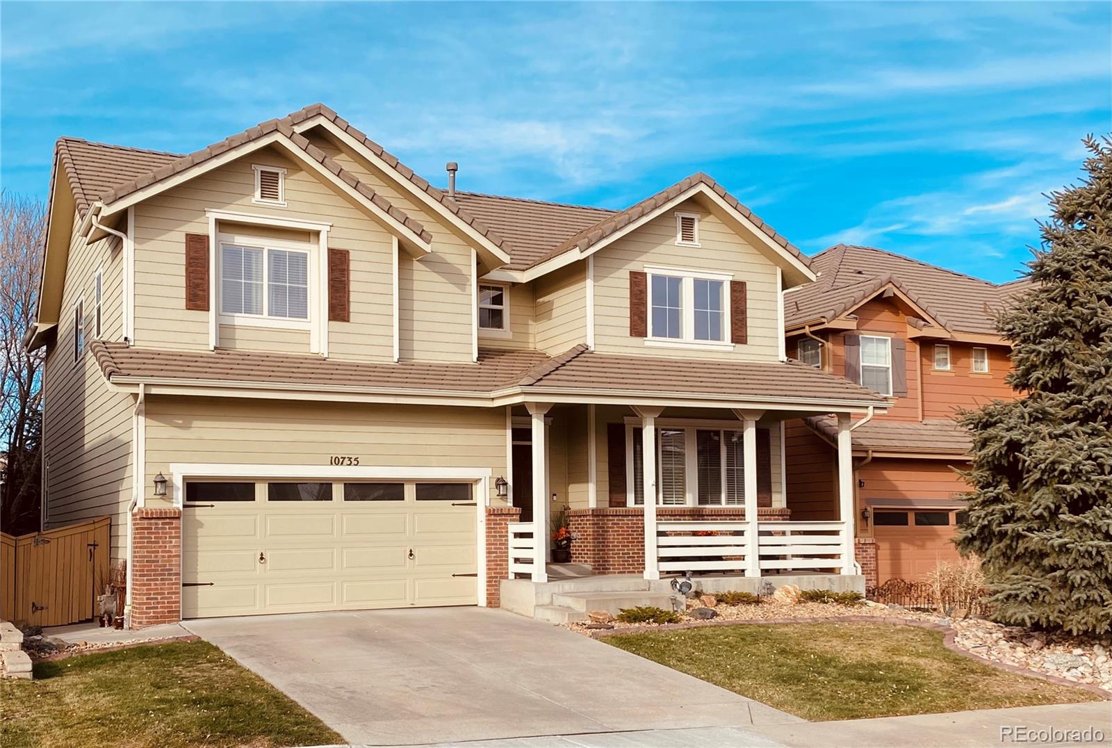 10735 Wynspire Road Highlands Ranch, CO 80130 - Photo 1 of 40 a front view of a house with yard and garage