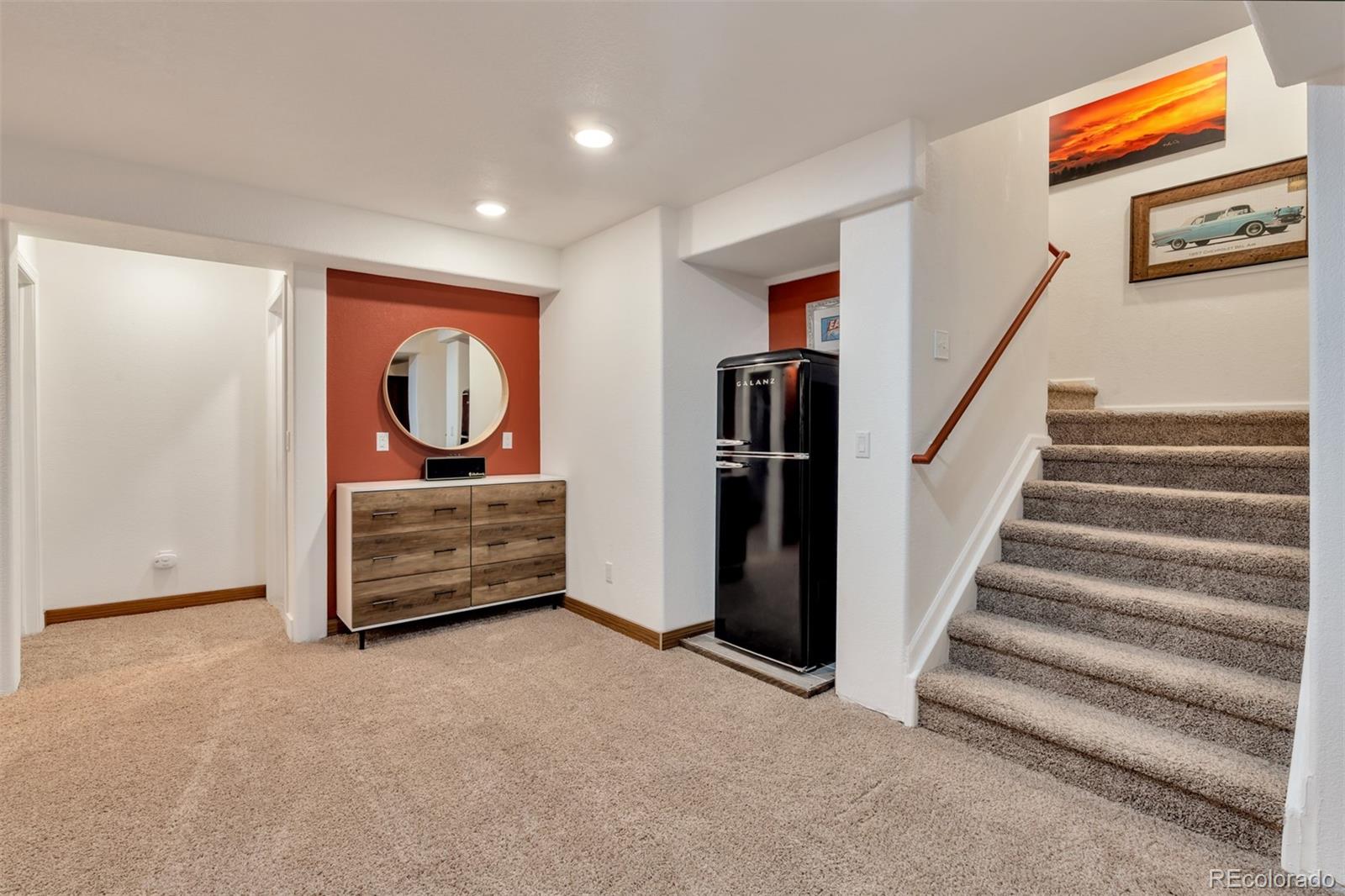 10735 Wynspire Road Highlands Ranch, CO 80130 - Photo 19 of 40 a room with stairs and a painting on the wall