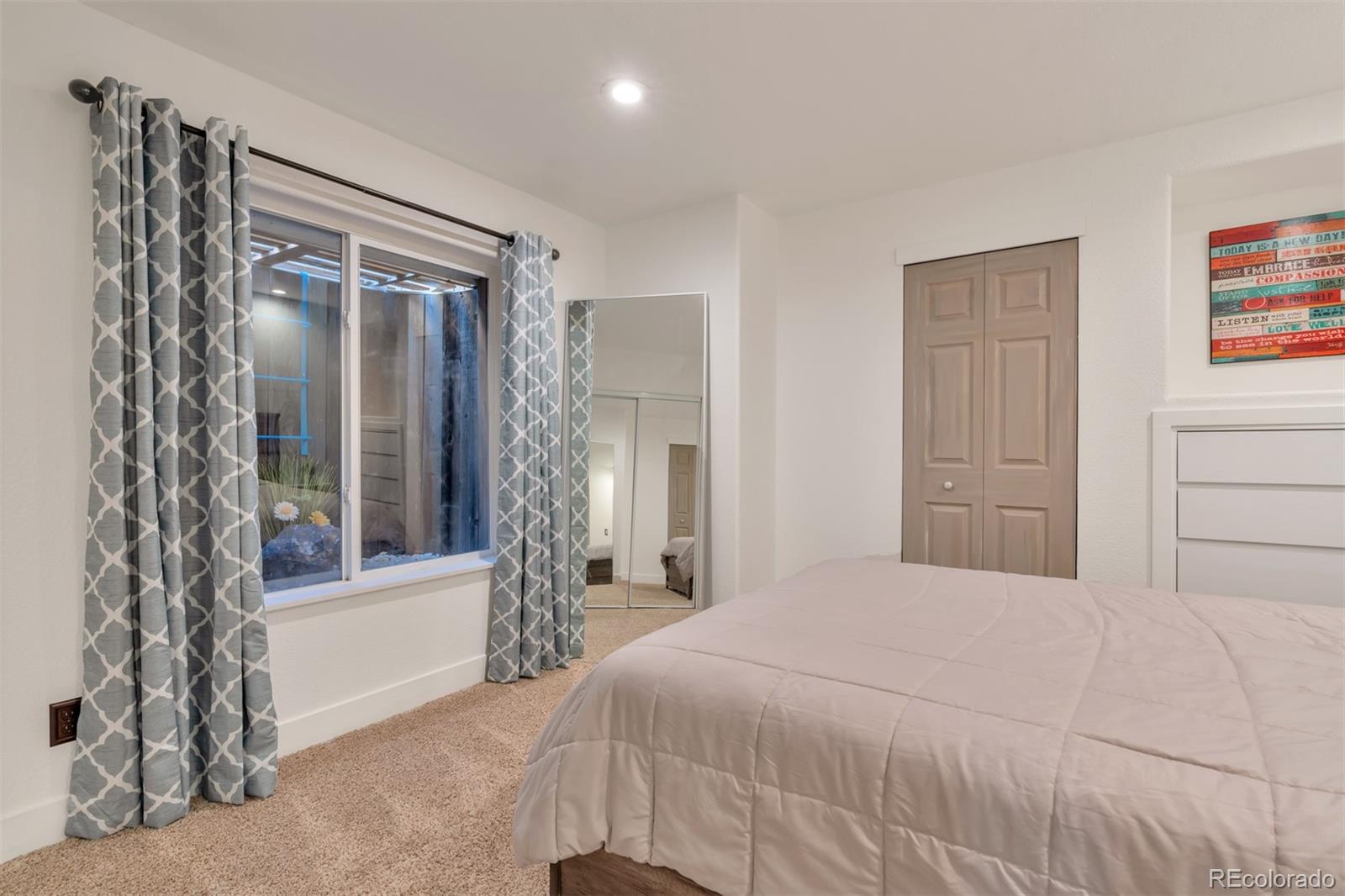 10735 Wynspire Road Highlands Ranch, CO 80130 - Photo 21 of 40 a bedroom with a large bed and a closet