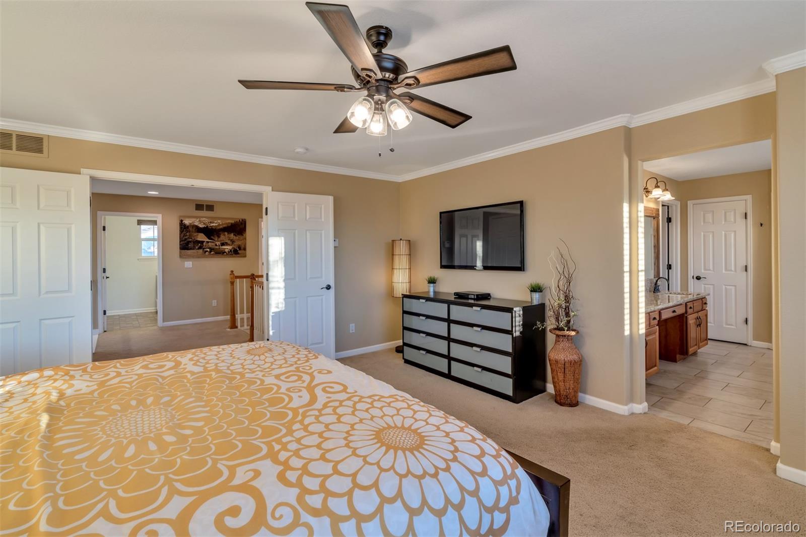 10735 Wynspire Road Highlands Ranch, CO 80130 - Photo 26 of 40 a bedroom with a bed and a flat screen tv