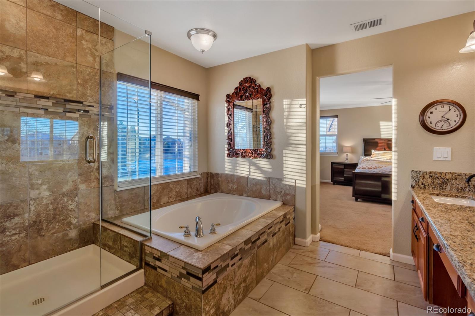 10735 Wynspire Road Highlands Ranch, CO 80130 - Photo 28 of 40 a bathroom with a tub a sink and a shower