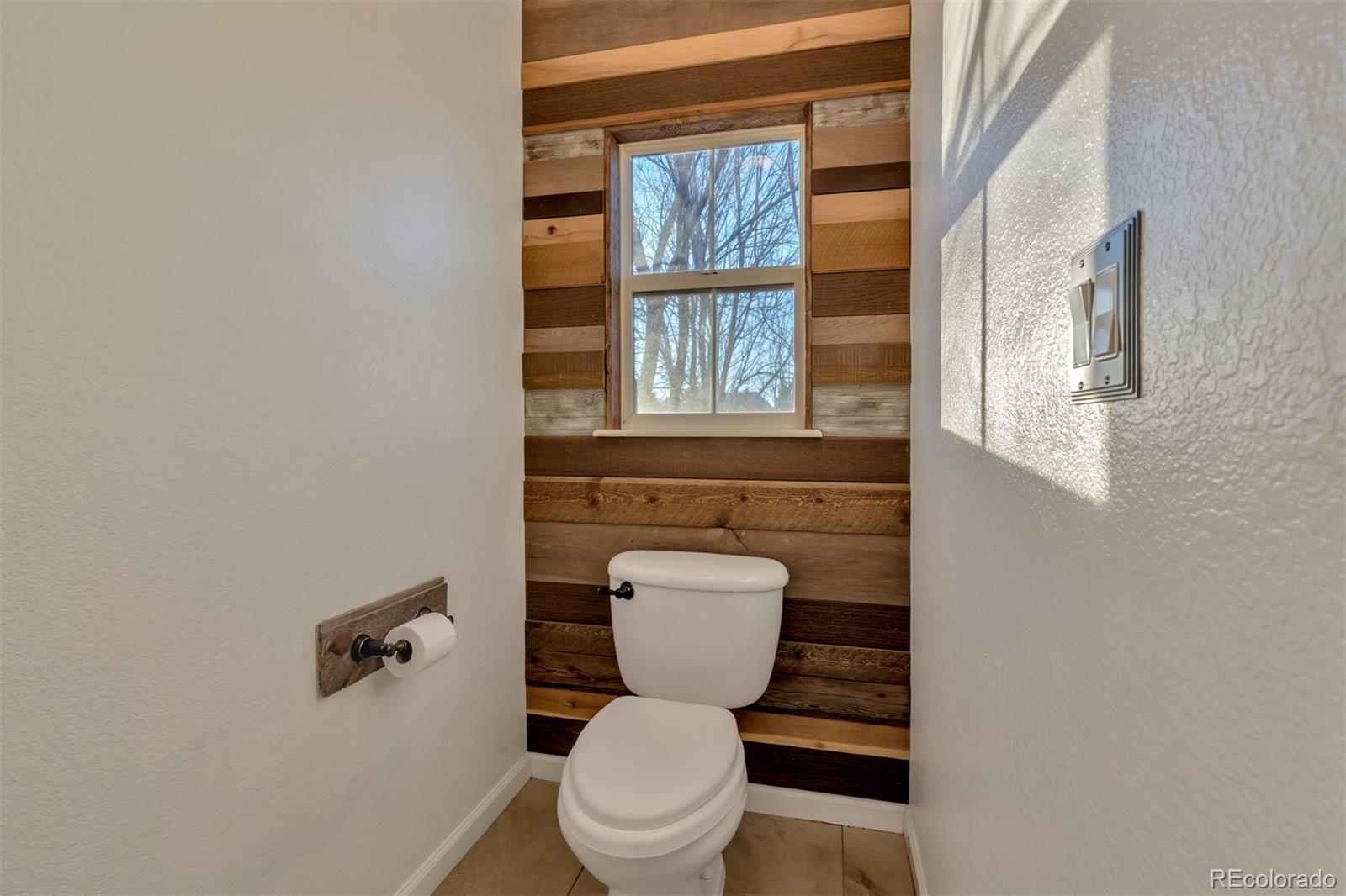 10735 Wynspire Road Highlands Ranch, CO 80130 - Photo 29 of 40 a bathroom with a toilet a sink and a window