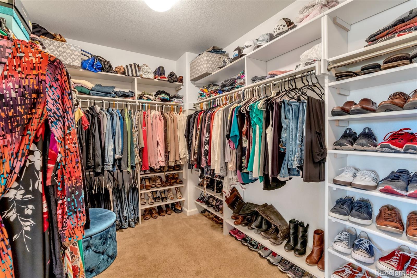 10735 Wynspire Road Highlands Ranch, CO 80130 - Photo 30 of 40 a view of walk in closet with clothes and shoes
