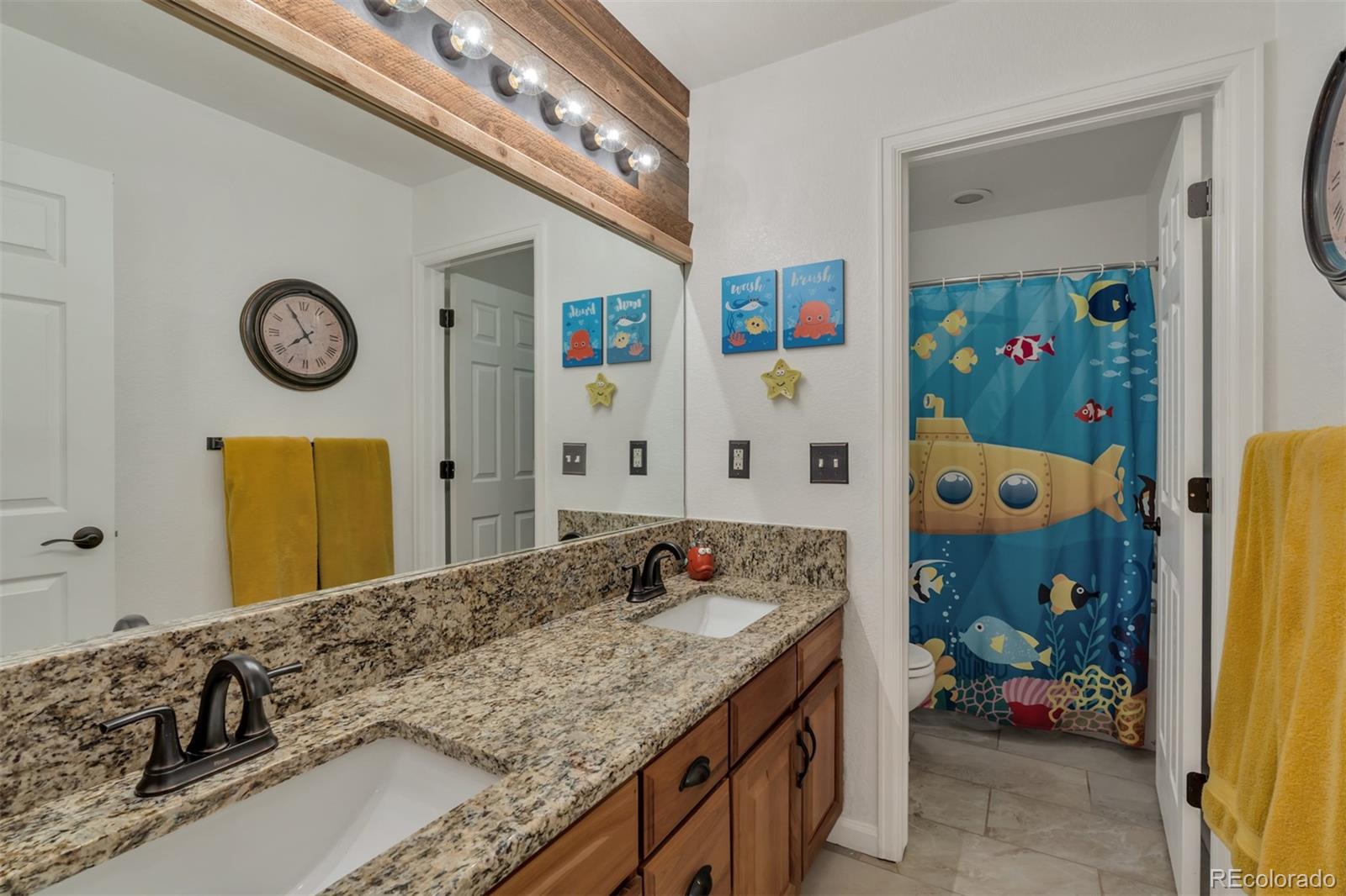 10735 Wynspire Road Highlands Ranch, CO 80130 - Photo 33 of 40 a bathroom with a granite countertop sink and a mirror