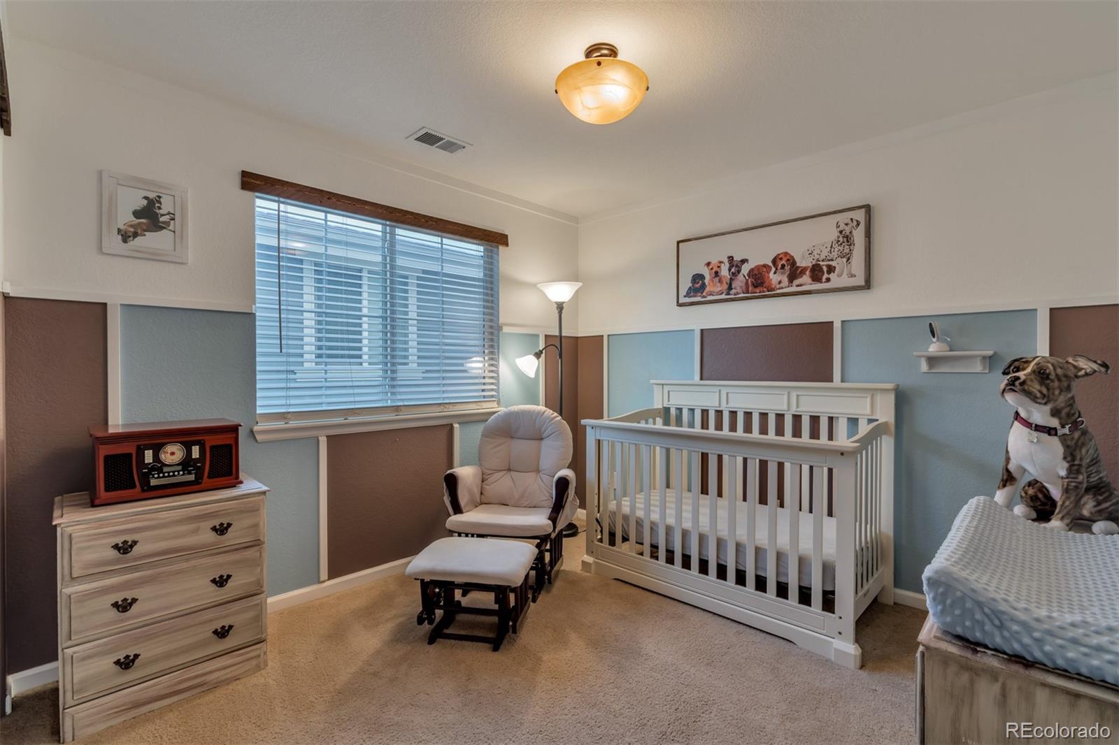10735 Wynspire Road Highlands Ranch, CO 80130 - Photo 35 of 40 a bedroom with furniture and a window