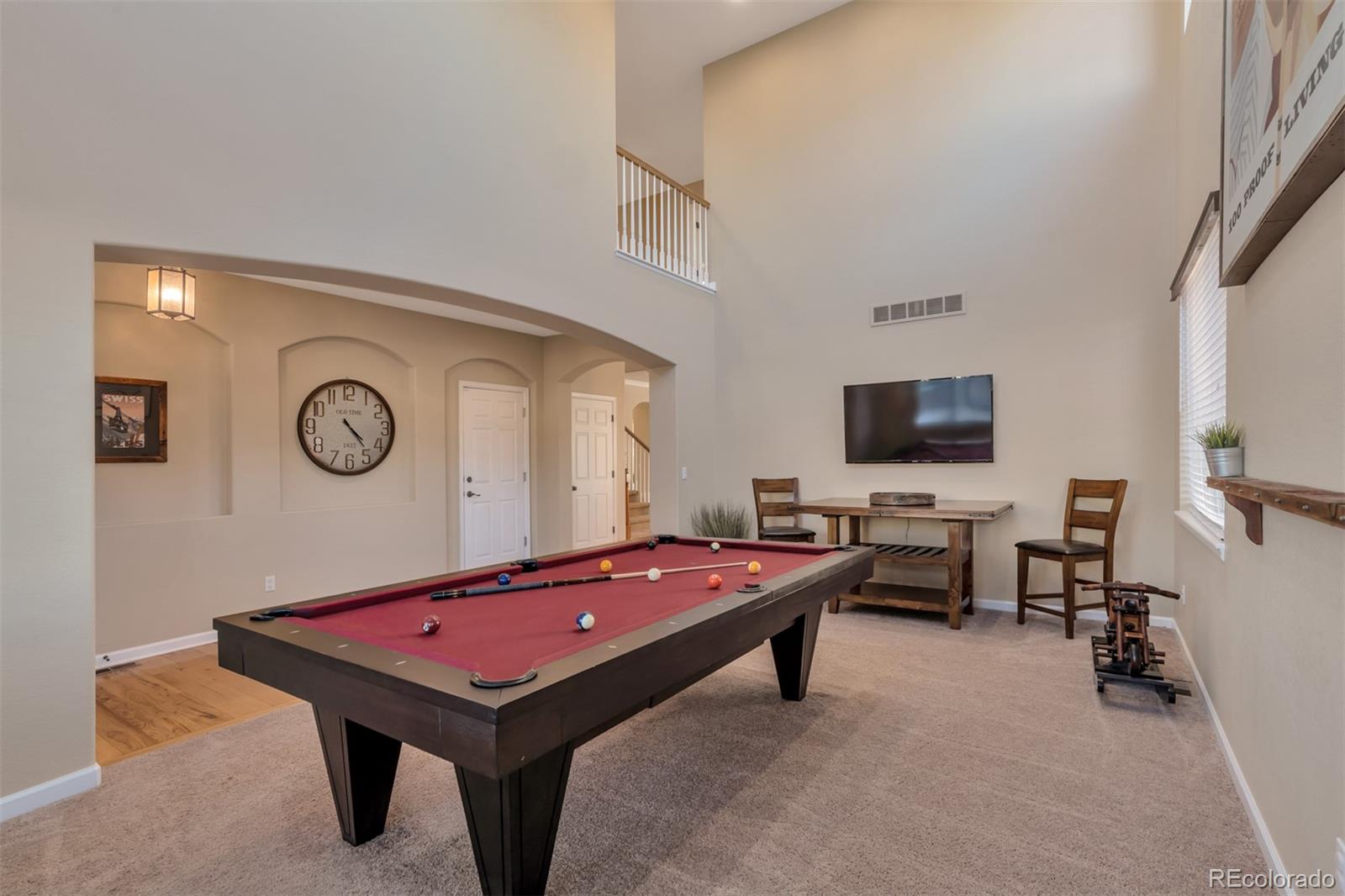 10735 Wynspire Road Highlands Ranch, CO 80130 - Photo 5 of 40 a room with furniture pool table and a flat screen tv