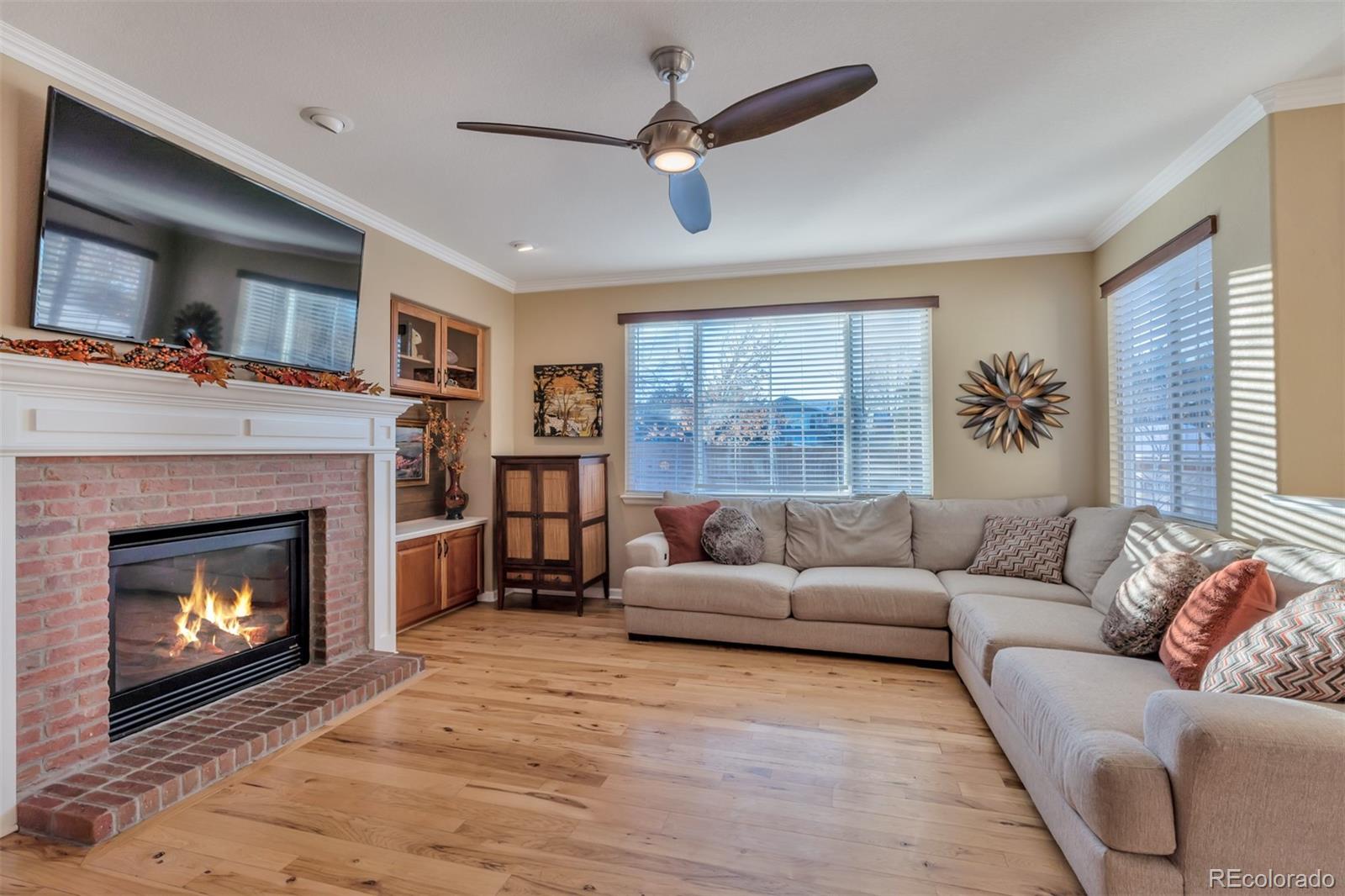 10735 Wynspire Road Highlands Ranch, CO 80130 - Photo 10 of 40 a living room with furniture and a fireplace