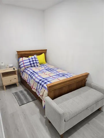 a bedroom with a bed and a lamp