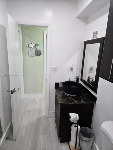 a bathroom with a sink a toilet a mirror and vanity
