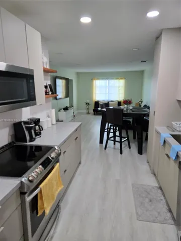 a kitchen with a refrigerator and a sink