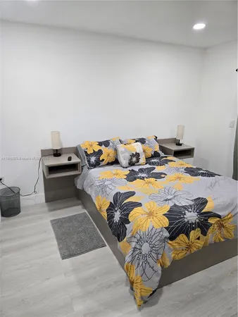 a bed sitting in a bedroom and dressers