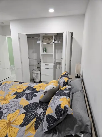 a bedroom with two beds and a couch