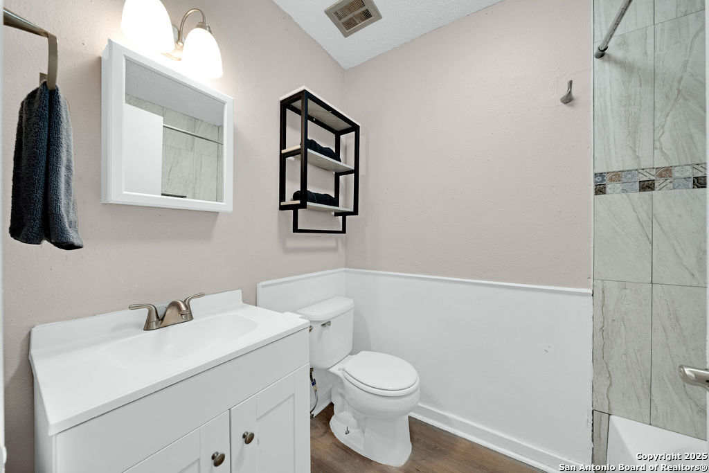 6706 Red Bluff Road San Antonio, TX 78218 - Photo 13 of 17 a white toilet sitting next to a bathroom sink