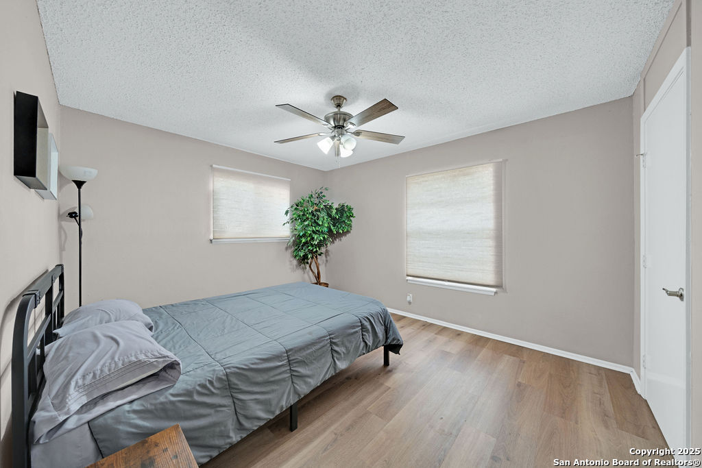 6706 Red Bluff Road San Antonio, TX 78218 - Photo 14 of 17 a bedroom with a bed and a ceiling fan