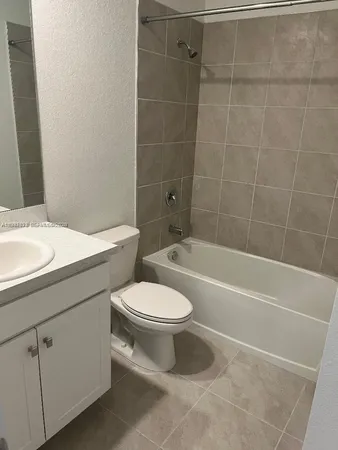 a bathroom with a toilet a sink and bathtub