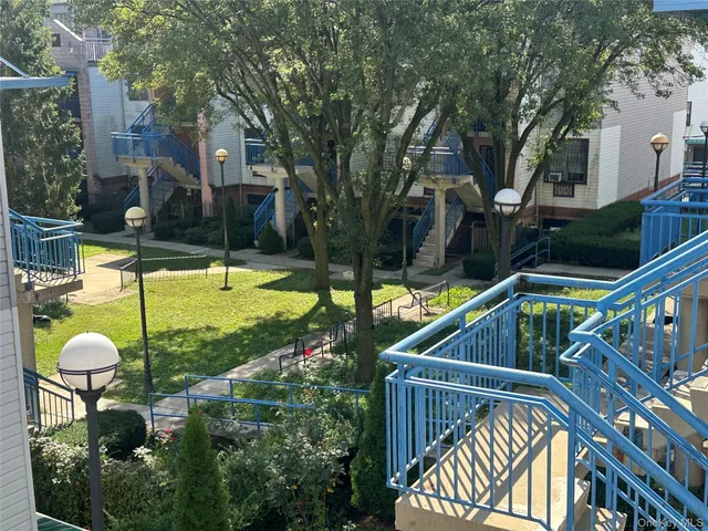 a view of a swimming pool with a patio and a fountain