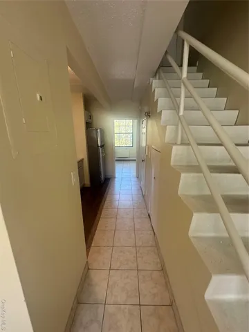 a kitchen with granite countertop white cabinets and stainless steel appliances