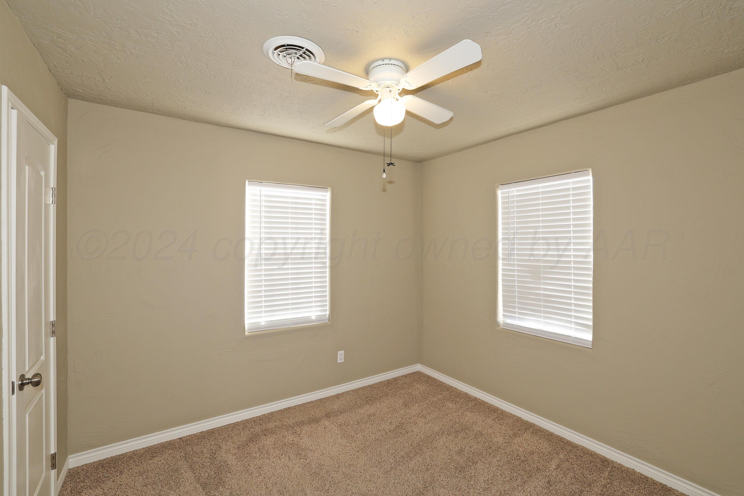 4612 South Parker Street Amarillo, TX 79110 - Photo 11 of 24 a view of an empty room with a window