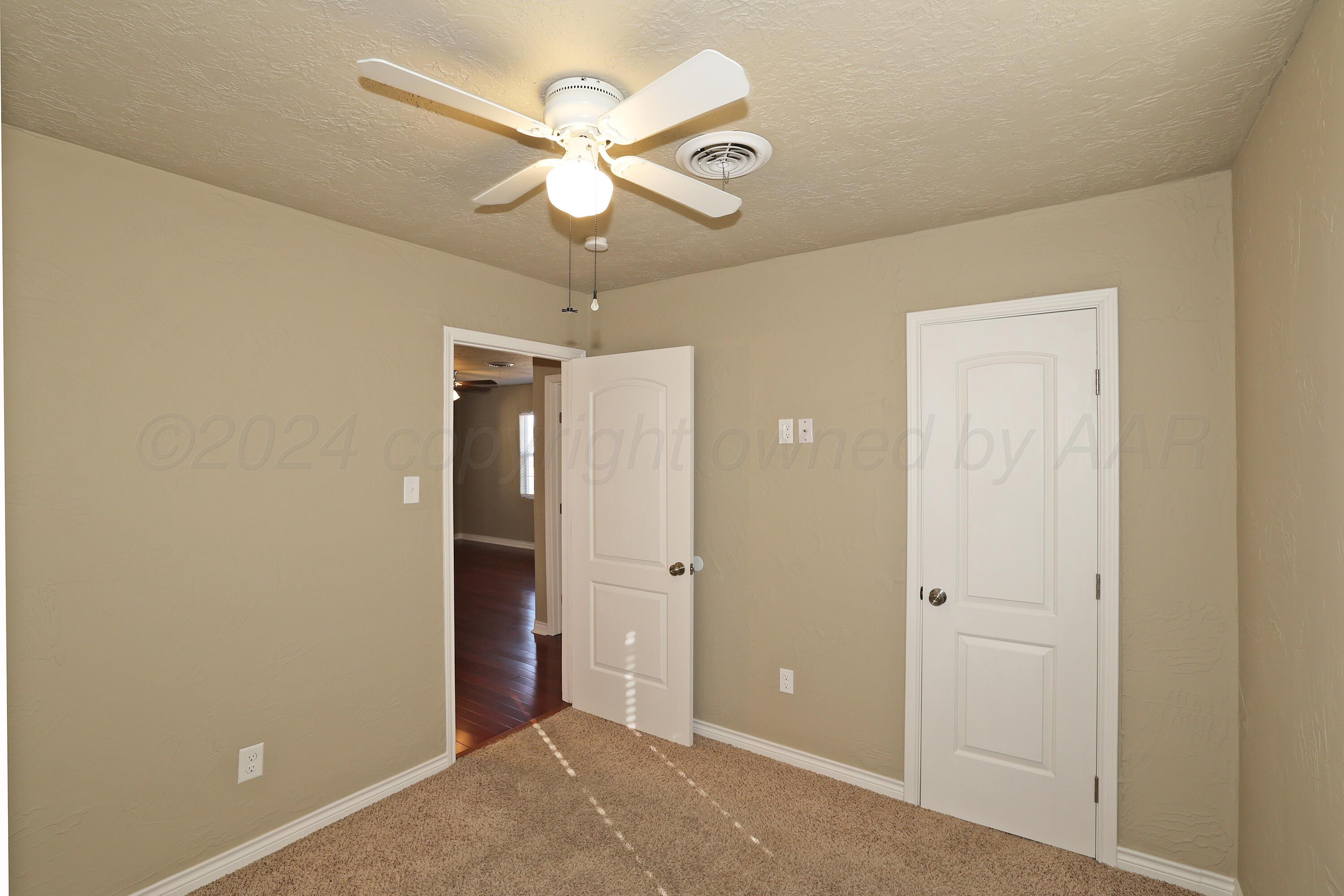 4612 South Parker Street Amarillo, TX 79110 - Photo 12 of 24 an empty room and chandelier fan