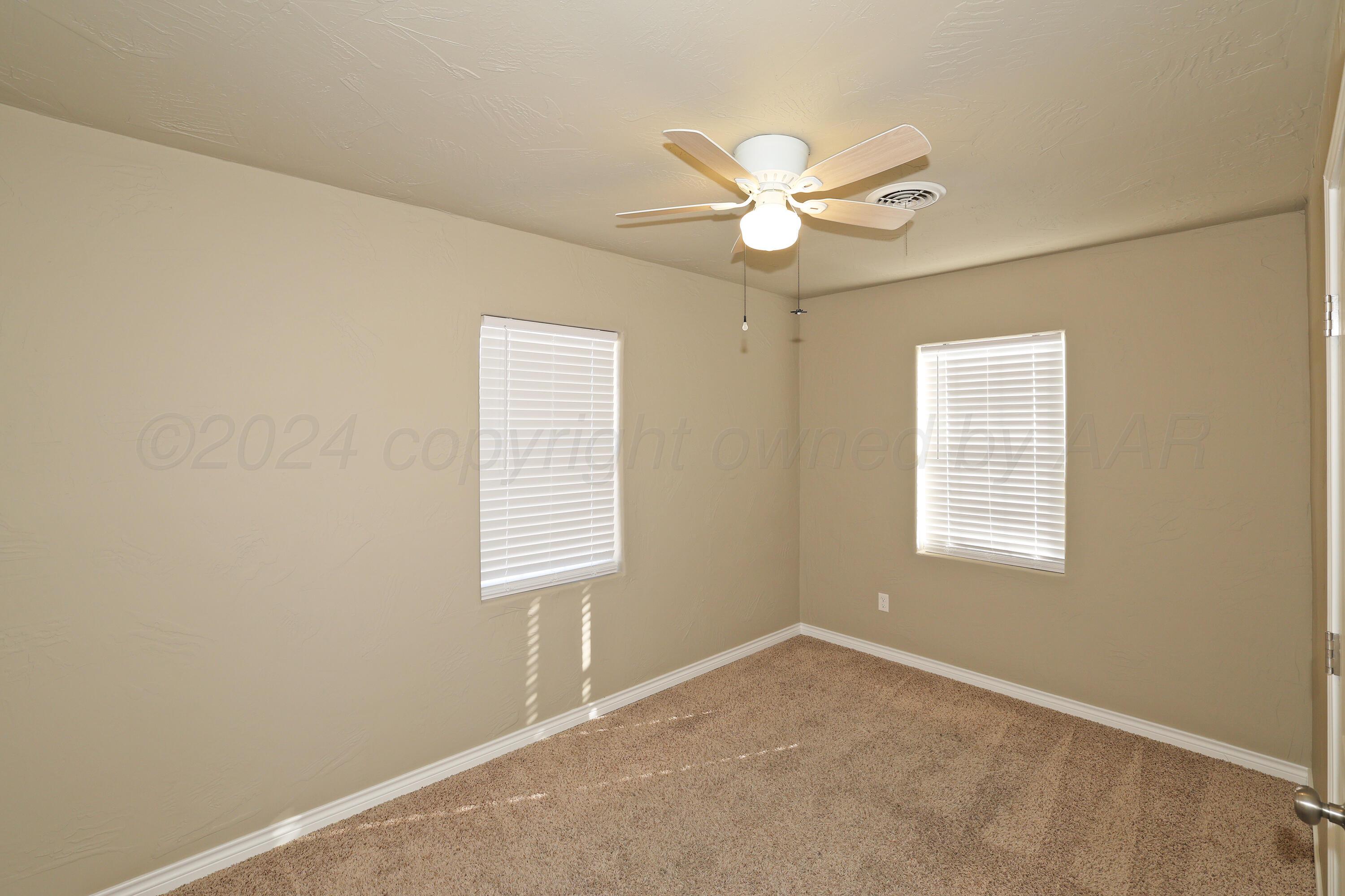 4612 South Parker Street Amarillo, TX 79110 - Photo 13 of 24 a view of an empty room with a window