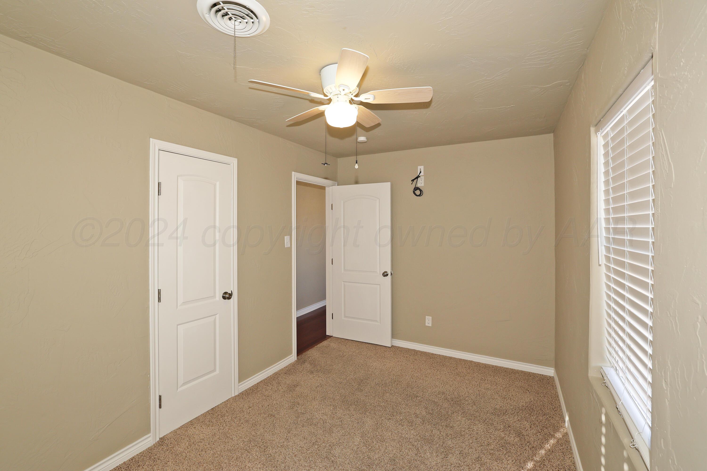 4612 South Parker Street Amarillo, TX 79110 - Photo 14 of 24 a view of a livingroom with a ceiling fan and window