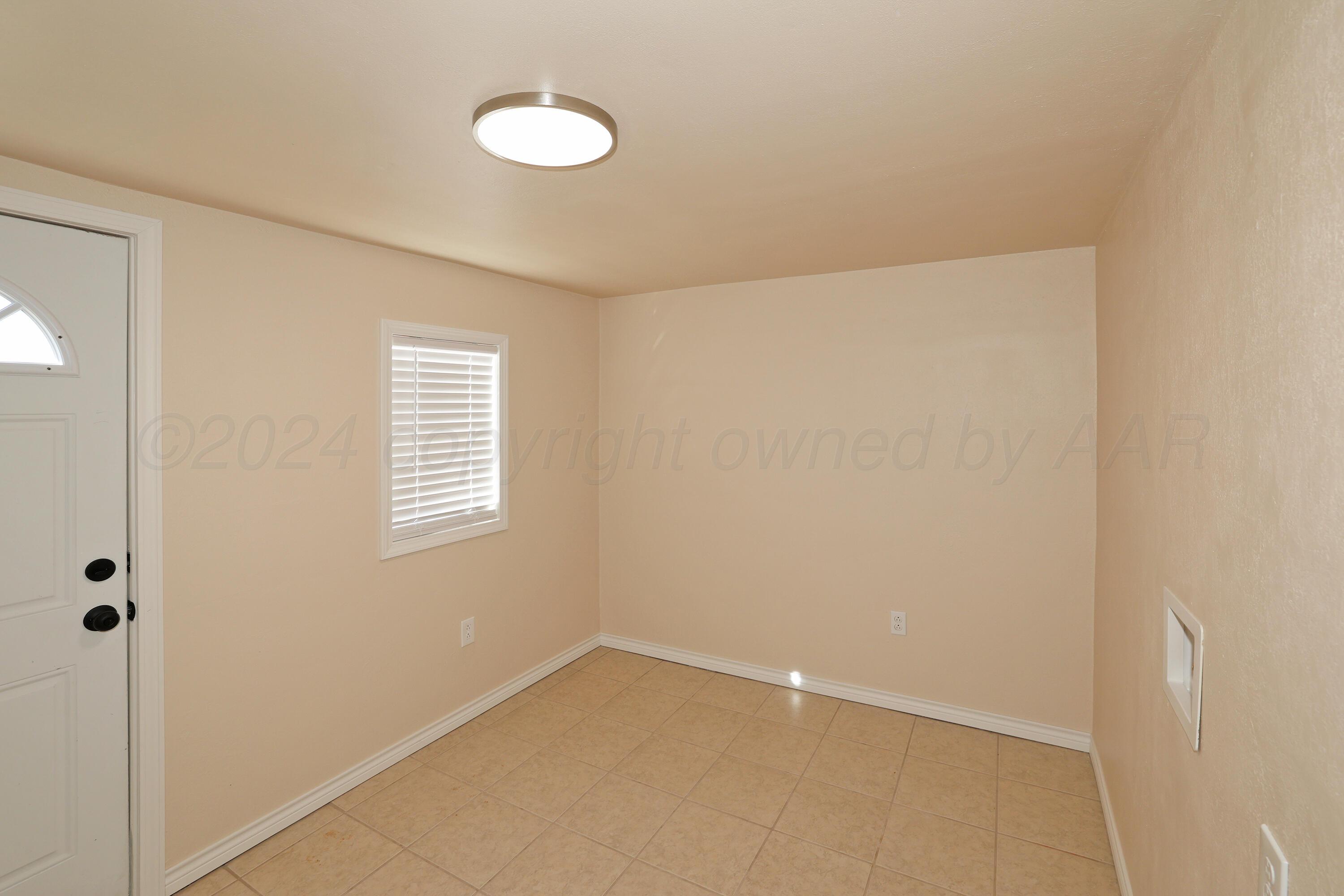 4612 South Parker Street Amarillo, TX 79110 - Photo 18 of 24 a view of an empty room with a window