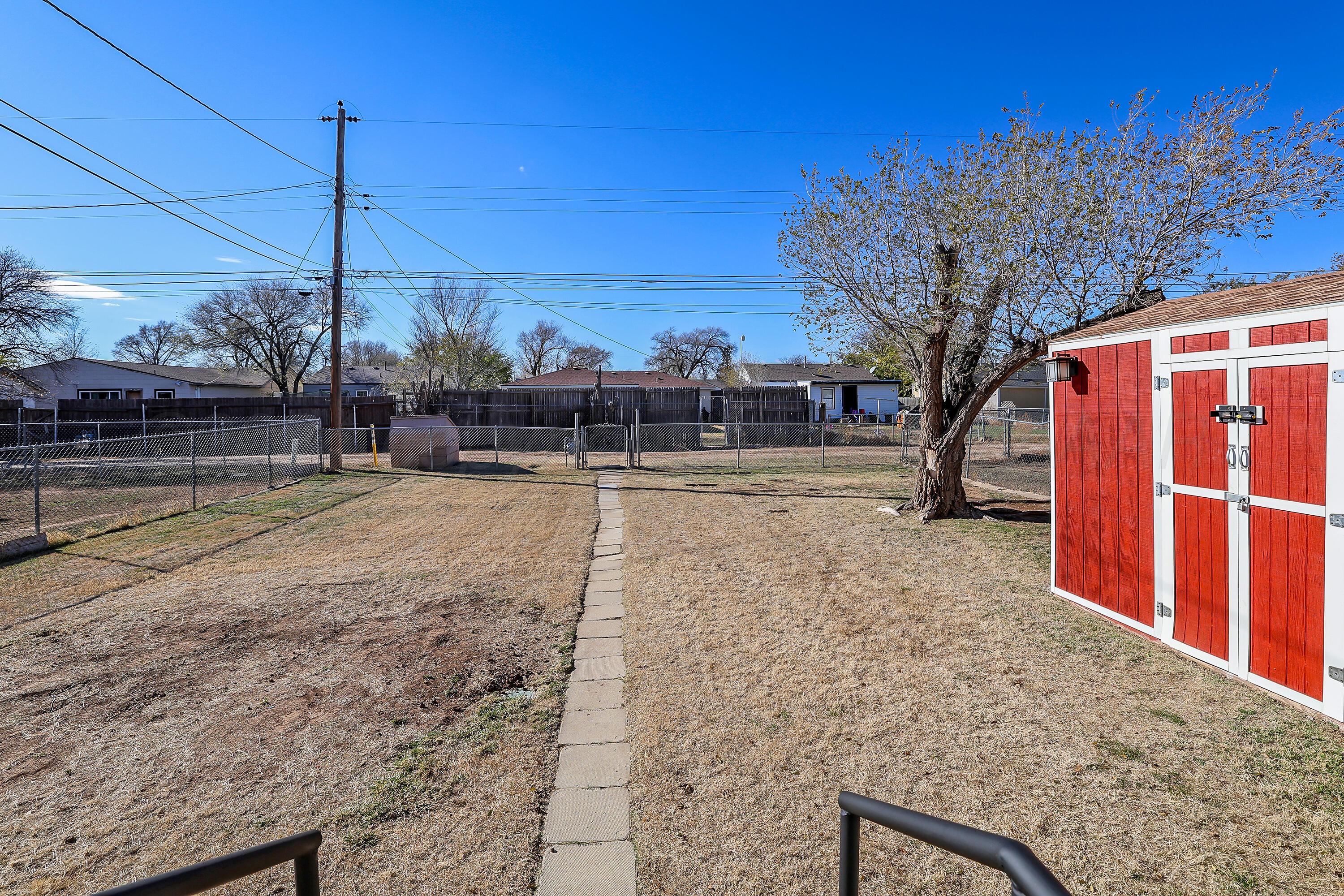4612 South Parker Street Amarillo, TX 79110 - Photo 20 of 24 a view of a yard with a tree