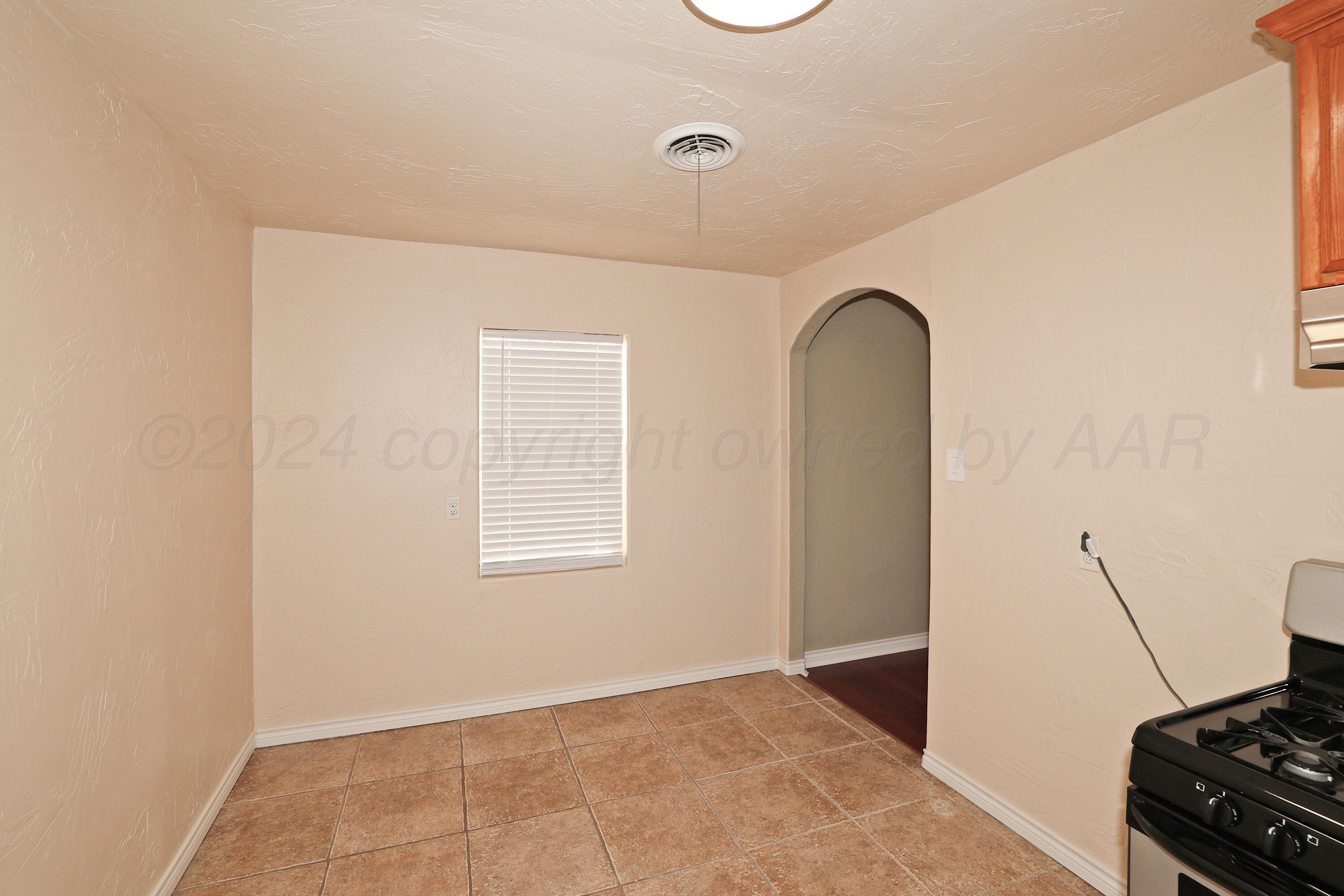 4612 South Parker Street Amarillo, TX 79110 - Photo 10 of 24 a view of an empty room with a fireplace
