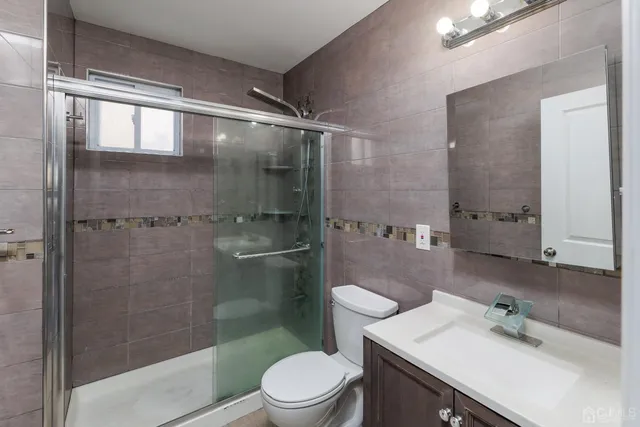 a bathroom with a sink mirror toilet and shower