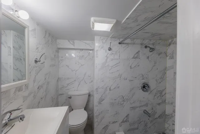 a bathroom with a toilet and a shower