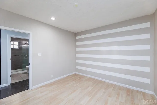 a view of room with wooden floor and windows