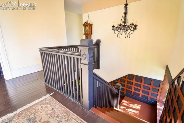 a view of a chandelier and wooden floor