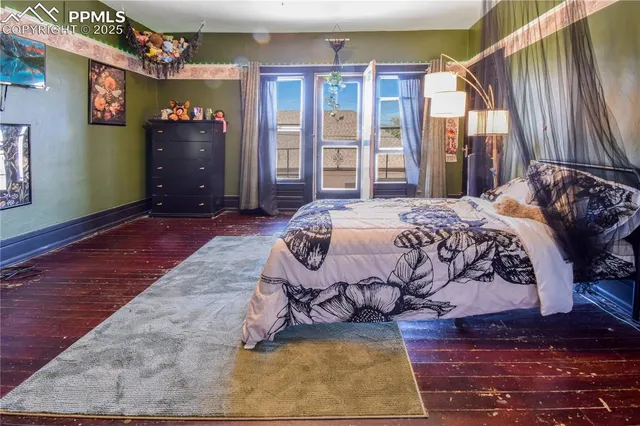 a bed sitting in a bedroom next to a window