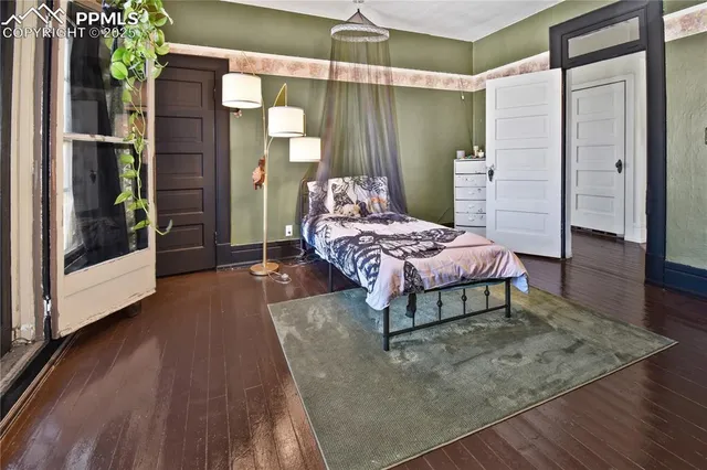 a bedroom with a bed and a mirror