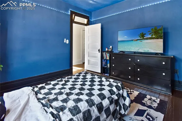 a bedroom with a bed and a flat screen tv