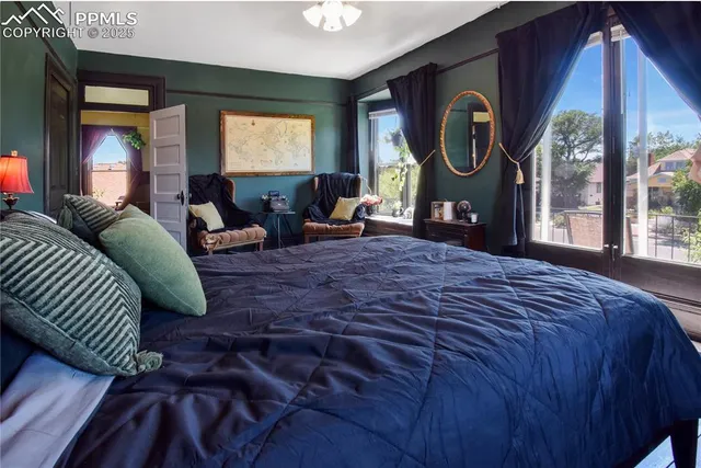 a bed sitting in a bedroom next to a window