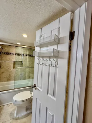 a bathroom with a shower a toilet and a shower