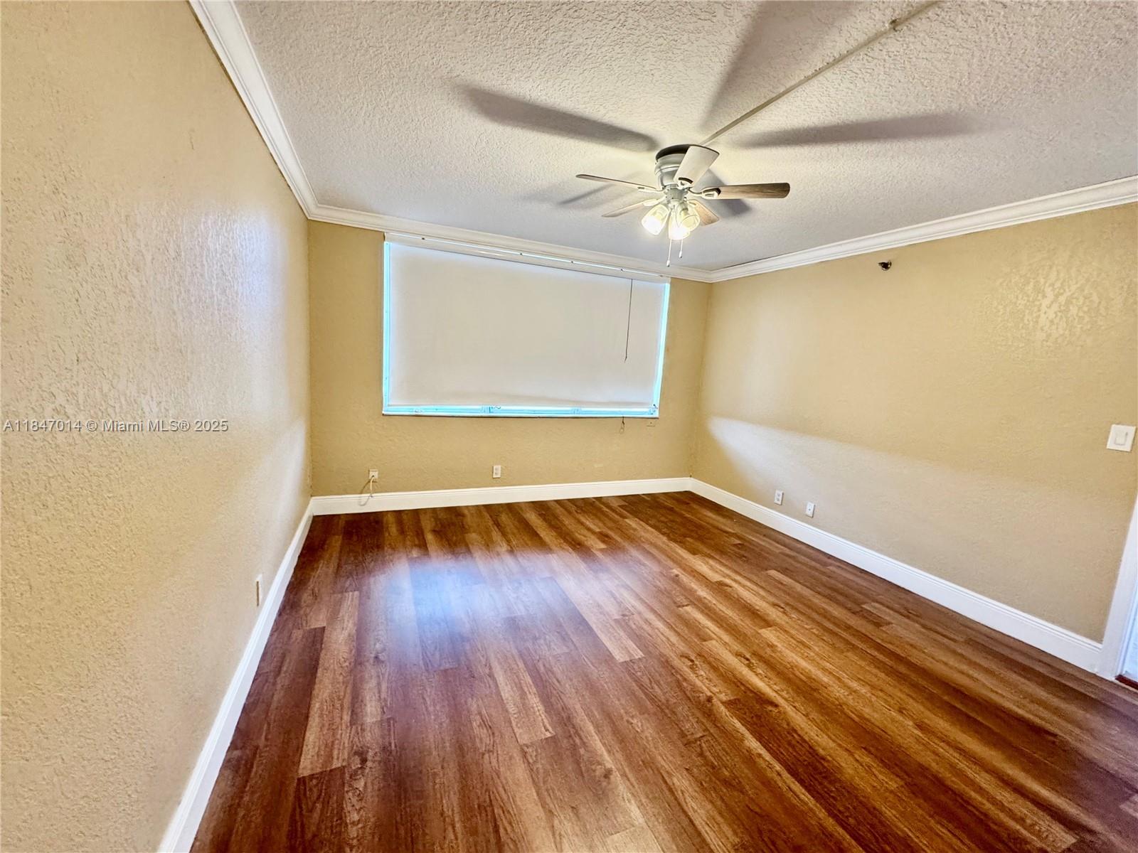 3100 West Rolling Hills Circle, Unit 407 Davie, FL 33328 - Photo 16 of 29 wooden floor in an empty room with a window