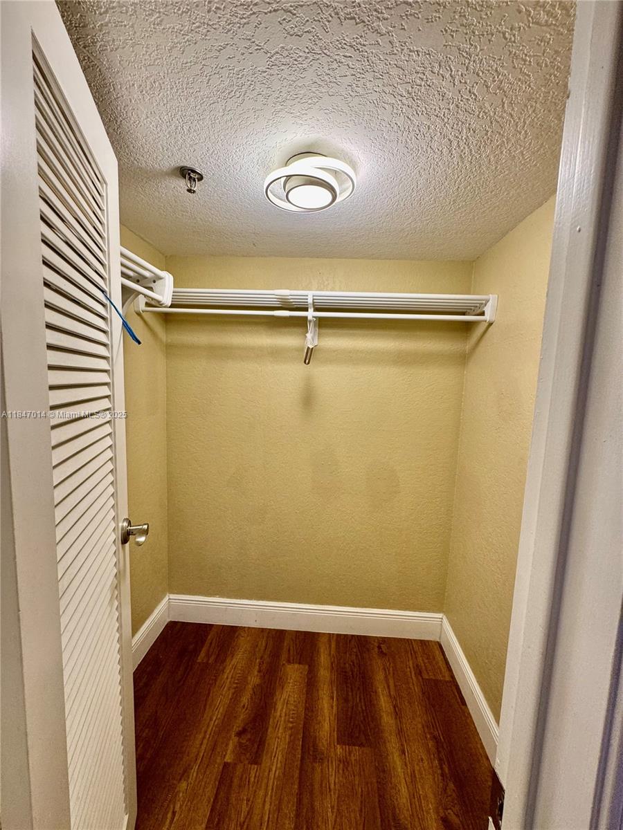 3100 West Rolling Hills Circle, Unit 407 Davie, FL 33328 - Photo 17 of 29 a view of closet with wooden floor