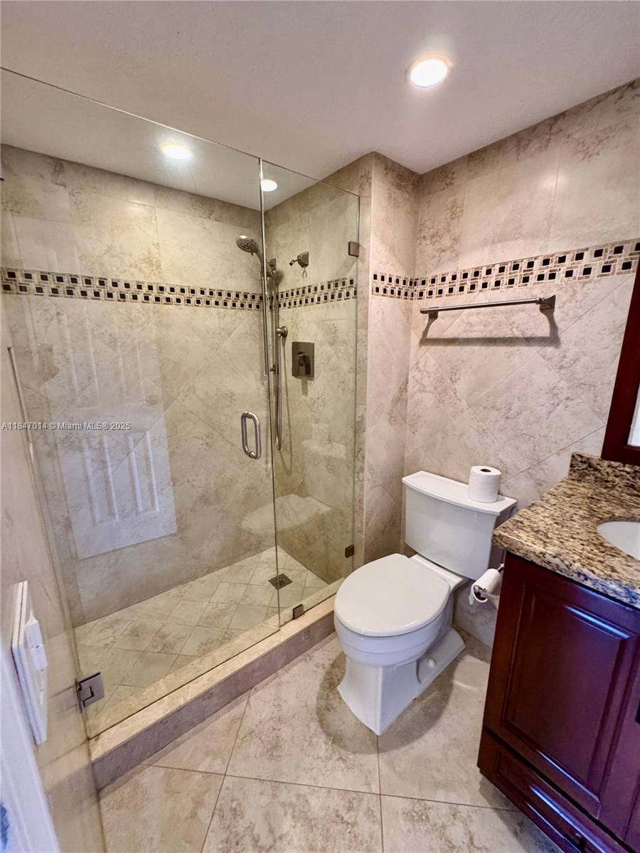 3100 West Rolling Hills Circle, Unit 407 Davie, FL 33328 - Photo 24 of 29 a bathroom with a toilet and a shower