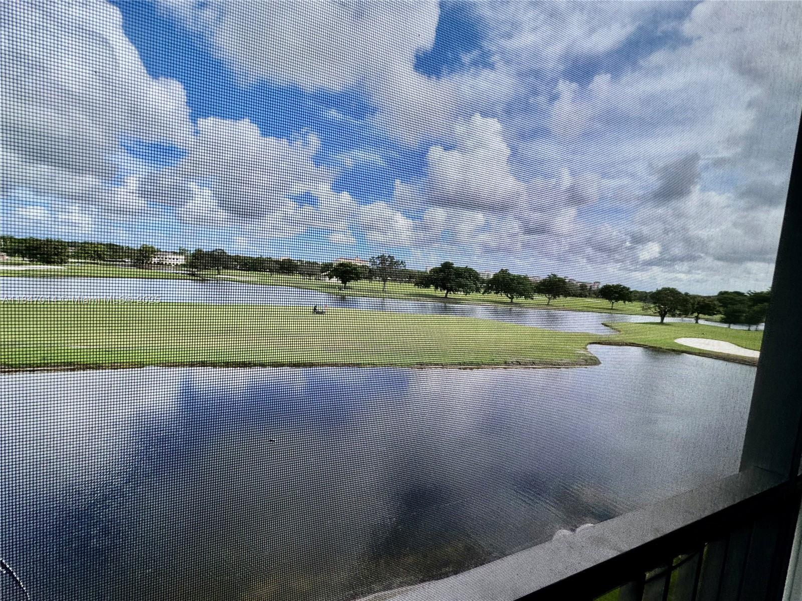 3100 West Rolling Hills Circle, Unit 407 Davie, FL 33328 - Photo 29 of 29 a view of a lake with houses in the back