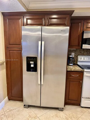 a kitchen with metallic refrigerator freezer and a dishwasher