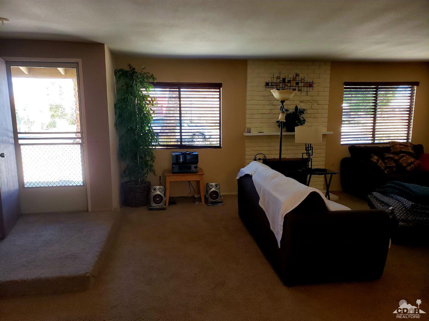 36883 Palmdale Road Rancho Mirage, CA 92270 - Photo 4 of 13 a living room with furniture and a large window