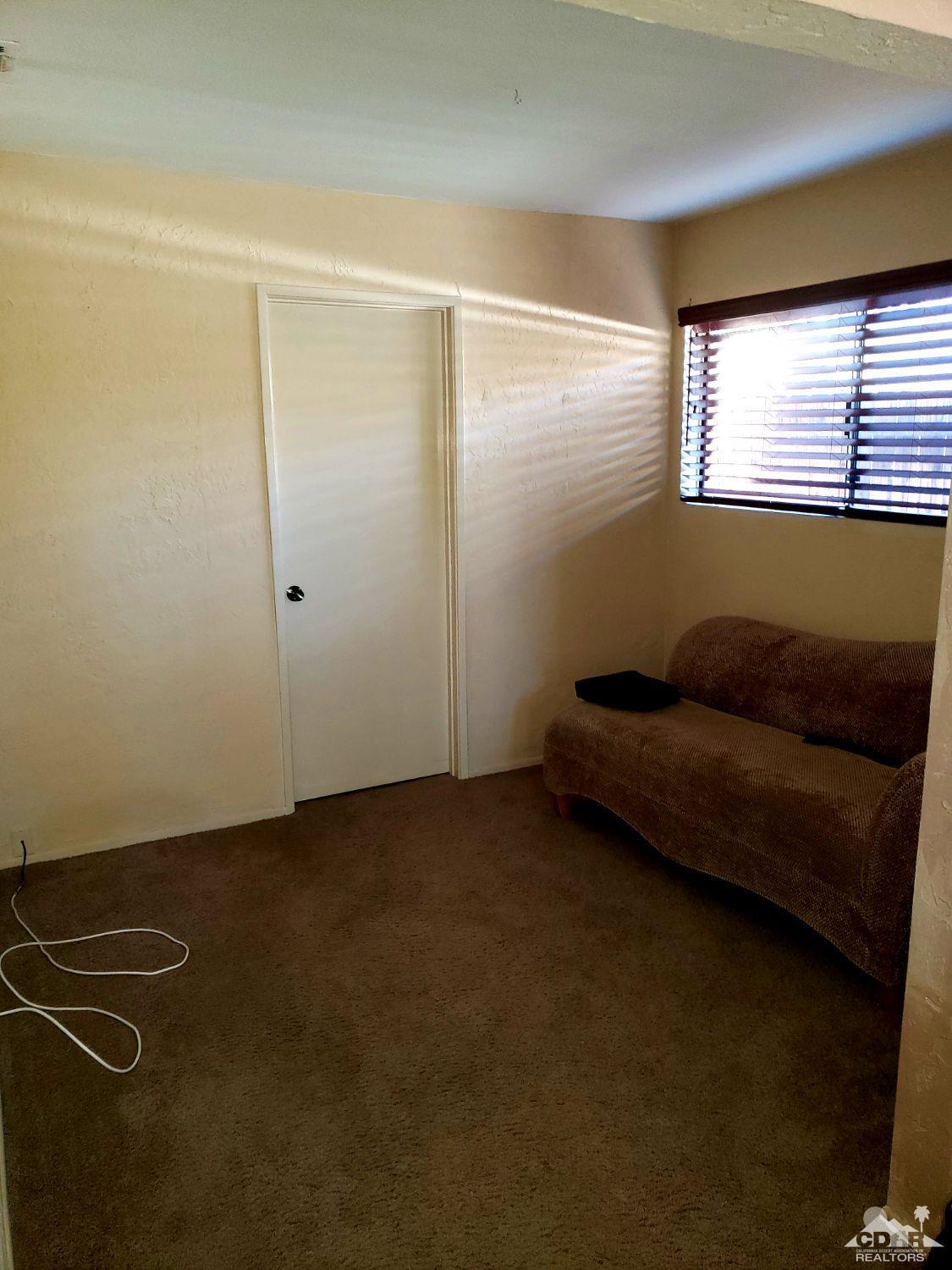 36883 Palmdale Road Rancho Mirage, CA 92270 - Photo 10 of 13 a living room with furniture and a window