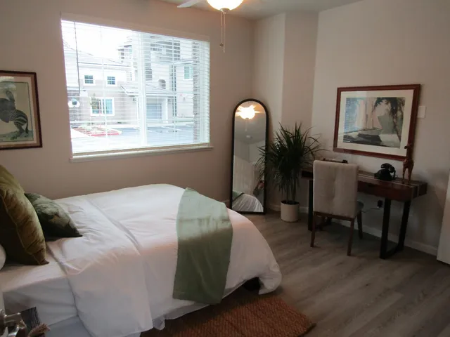 a bedroom with a bed and a mirror